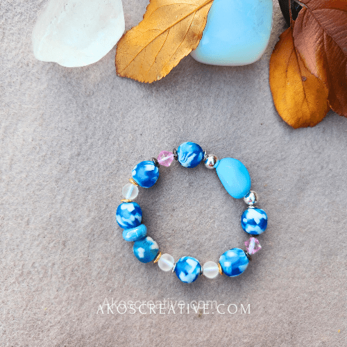 blue beads bracelets laying next to healing stones